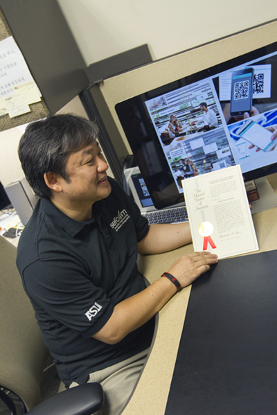 Gail-Joon Ahn is pictured with one of his patent certificates. He has earned six U.S. patents for his research in user-centric identity management and was recently named a Distinguished Scientist by the Association for Computing Machinery. Photographer: Nora Skrodenis/ASU