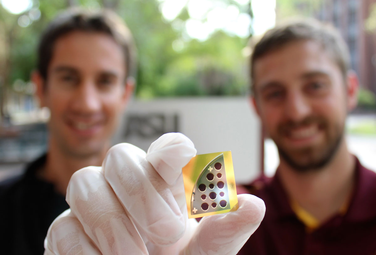Mathieu Boccard (left) and Jacob Becker (right) pose with a 20 percent CdTe solar cell developed in tandem by Yong-Hang Zhang's and Zachary Holman's laboratories