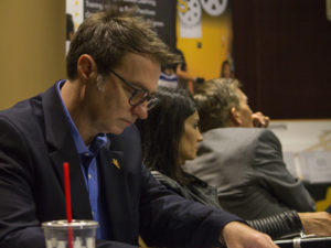 Assistant Professor of biomedical engineering Jamie Tyler, also the cofounder and chief science officer of Thync, takes notes during a pitch at eSeed Demo Day, November 30, 2016, while Lawdan Shojaee, co-founder and CEO of Axosoft, and Matt Likens, the founder and former CEO of Ulthera look on in the background. Photographer: Marco-Alexis Chaira/ASU