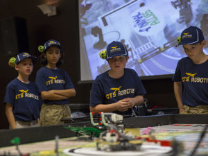 Members of the Cheyenne Roadrunners team, from Cheyenne Traditional Elementary School in Scottsdale, Arizona, watch as their robot navigates the course at the state championship tournament on January 15, 2017. Photographer: Jessica Hochreiter/ASU