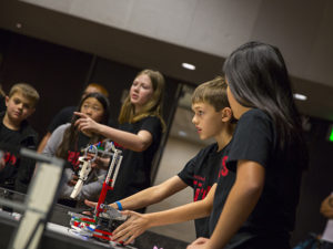 Team members of the Firebots, hailing from Scottsdale, Arizona, line up their robot's route at the FIRST® LEGO League state championship tournament on January 14, 2017. Photographer: Pete Zrioka/ASU