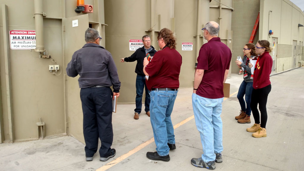 This picture shows members of the Arizona State University Industrial Assessment Center listening to an industry client during a site visit. 