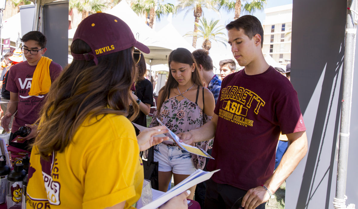 Photo of pair of students talking to another student. Caption: Students meet members of the nearly 60 Fulton Schools student clubs and organizations to explore their interests. Photographer: Jessica Hochreiter/ASU