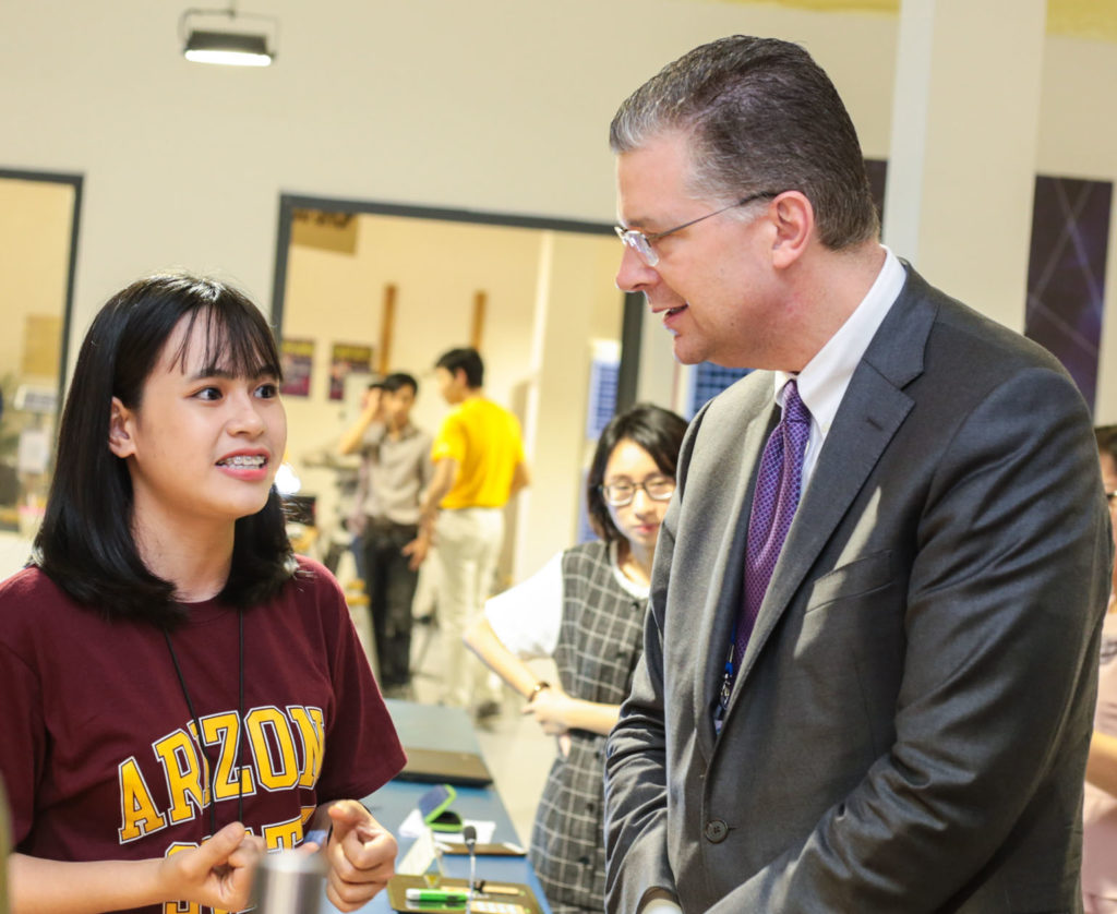 Photo of Daniel Kritenbrink speaking to a female student. Caption: Daniel Kritenbrink, U.S. Ambassador to Vietnam, speaks with a University of Da Nang student about the project she’s working on in the new ASU-USAID Maker Innovation Space.