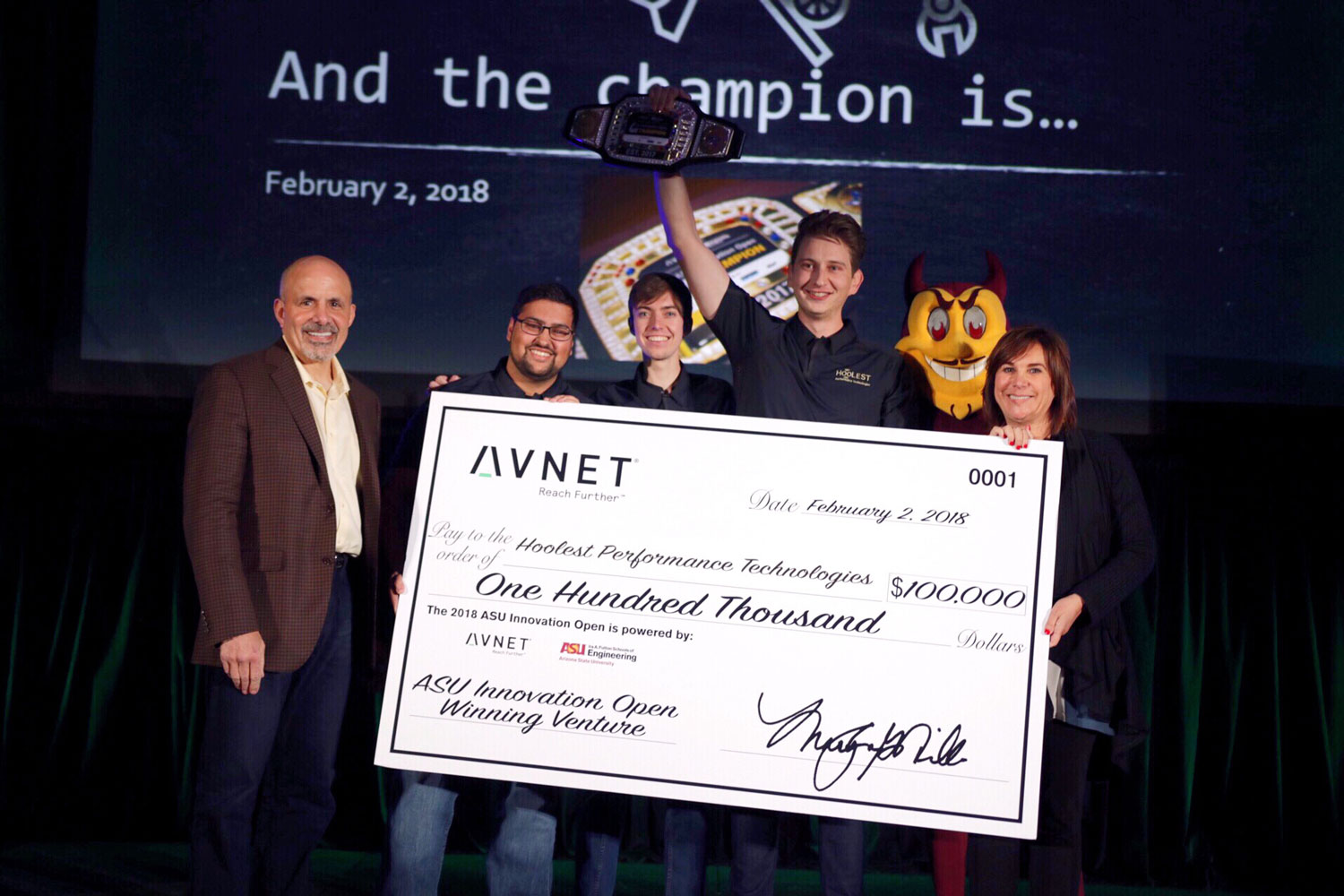 Hoolest Performance Technology's Nicholas Hool (fourth from left) holds up the championship belt after his team won 1st place and $100,000 at the 2018 ASU Innovation Open finals on February 2. 
