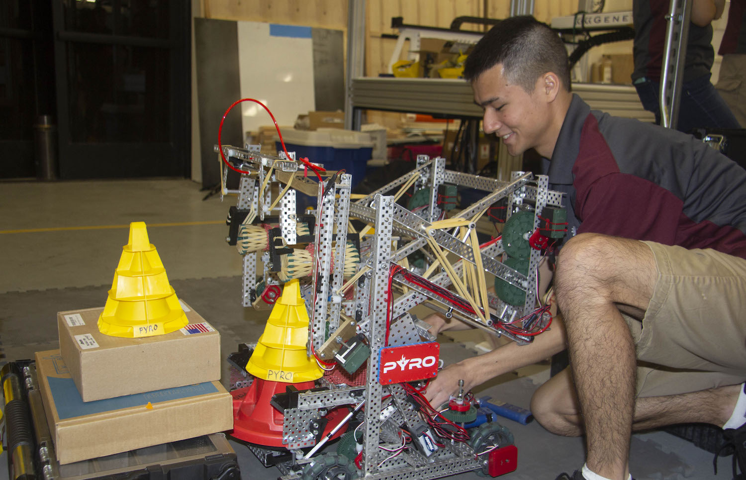 Photo of student working on a robot. Caption: Ryan Bodhipaksha, a robotics engineering major at Arizona State University and co-lead of PYRO Robotics, practices with the team’s robot to prepare for the VEX Robotics World Championship 2018. Photo courtesy of Samantha Blokker