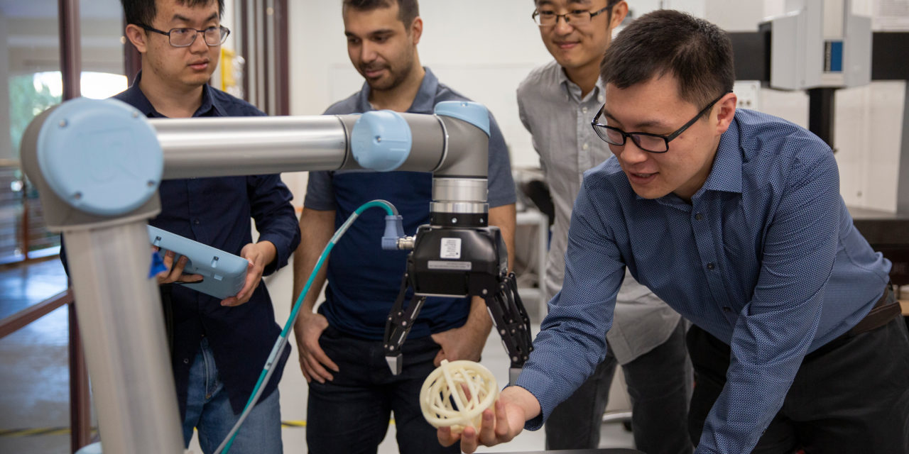 professor and students working with a 3D printed object