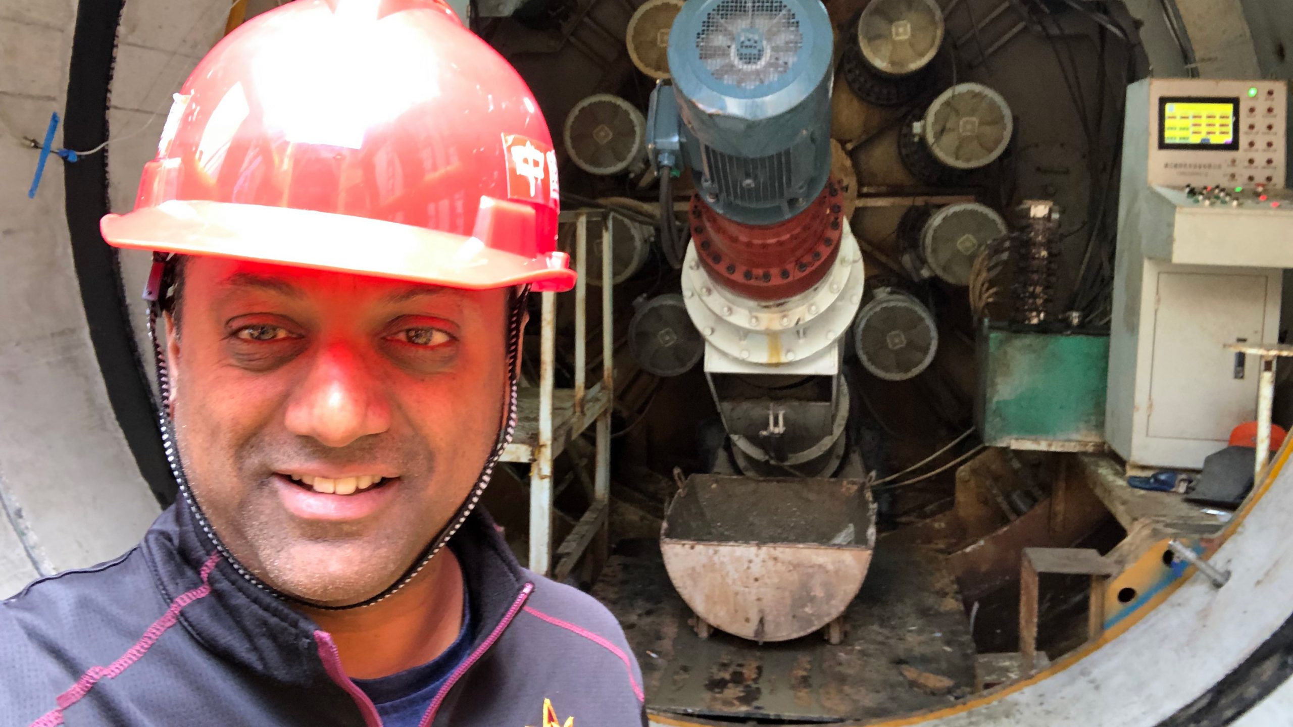 Sam Ariaratnam in front of a pipe