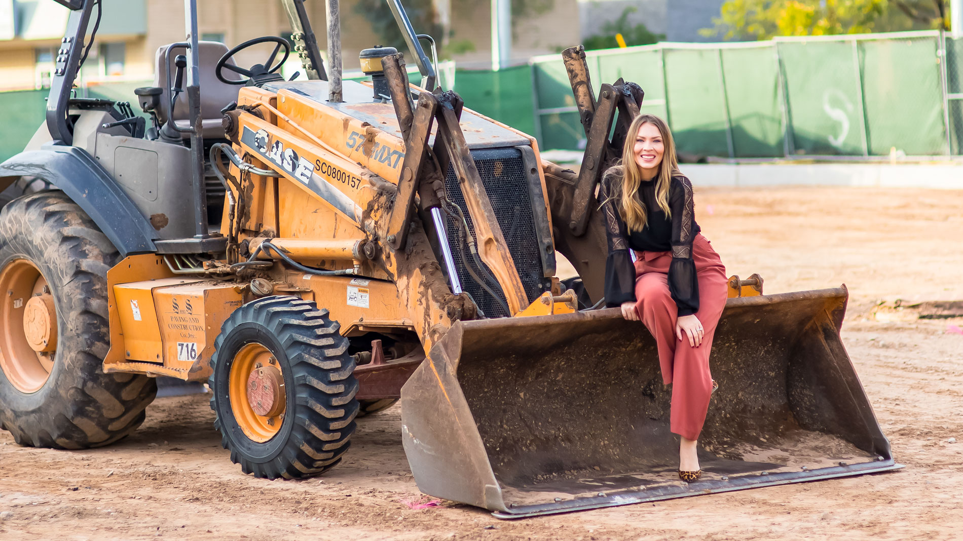 Tiffany Sharp poses with a bulldozer.