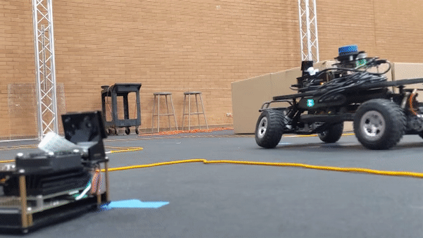animated .gif showing two small scale autonoumous vehicles driving on a track