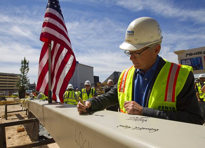 Jeff Ehret signing his name on a piece of steel