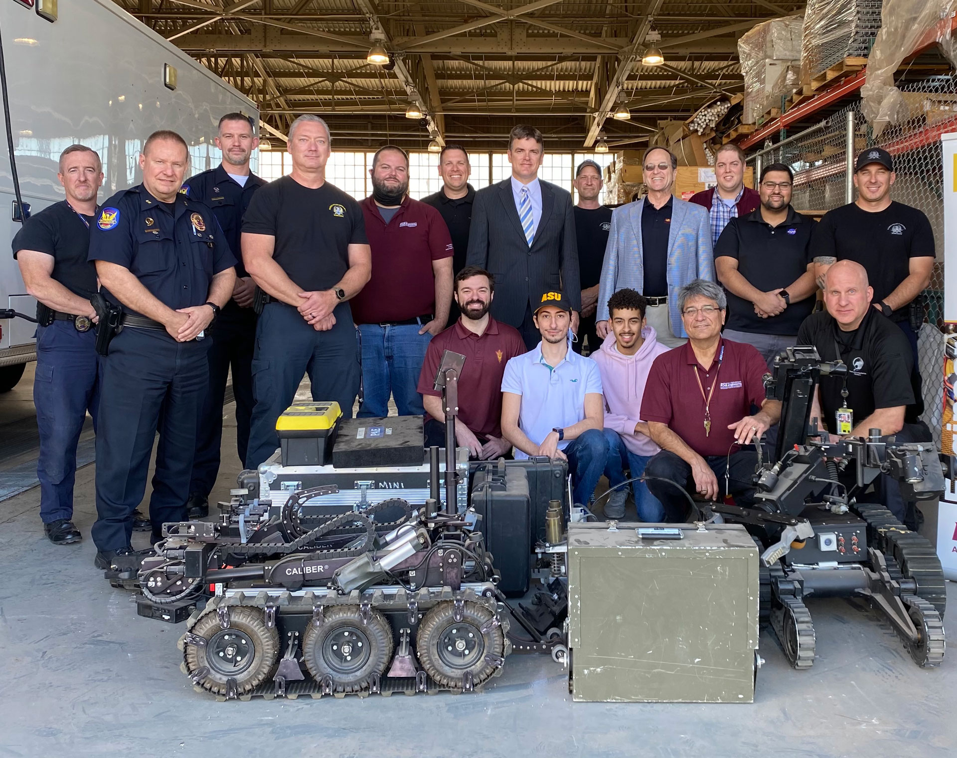 A group of police officers and students along with robots