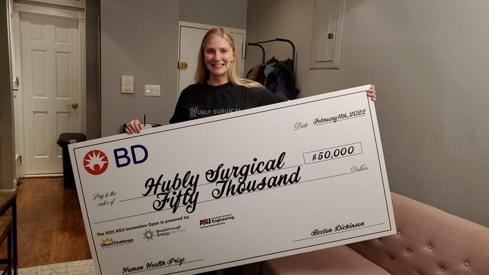Casey Grage holding an oversized check