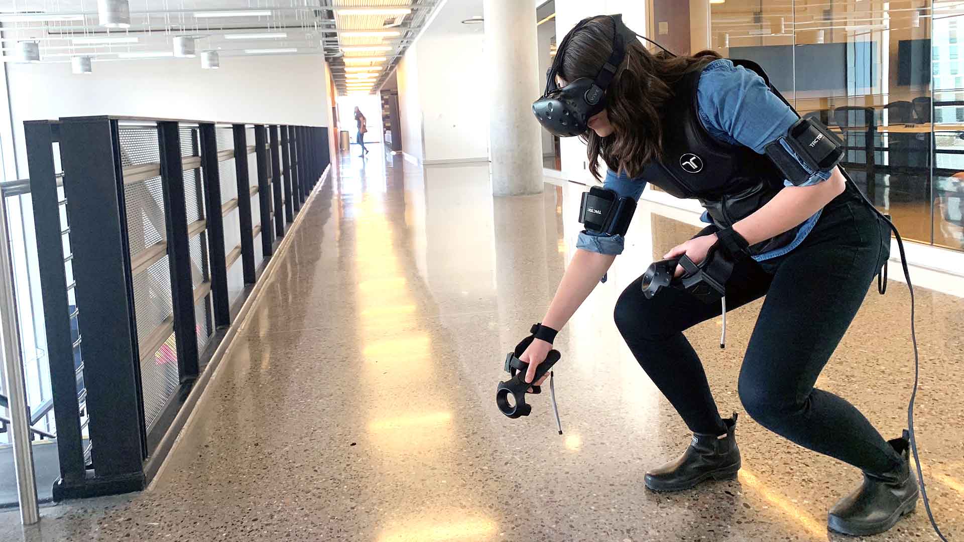 student wearing virtual reality gear and bending down