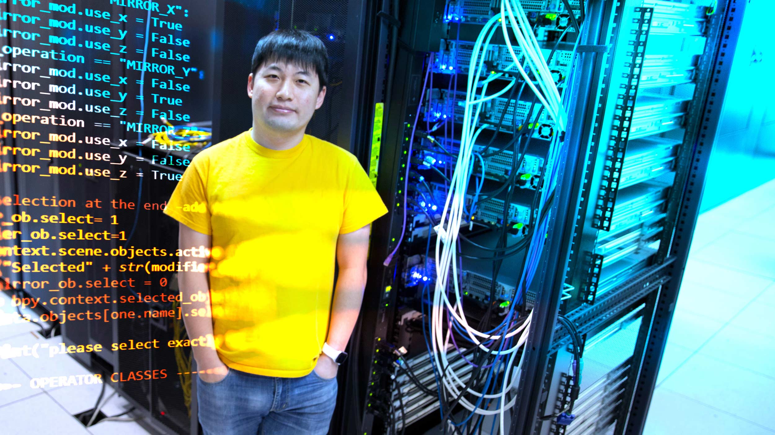 Fish Wang standing next to computer processors