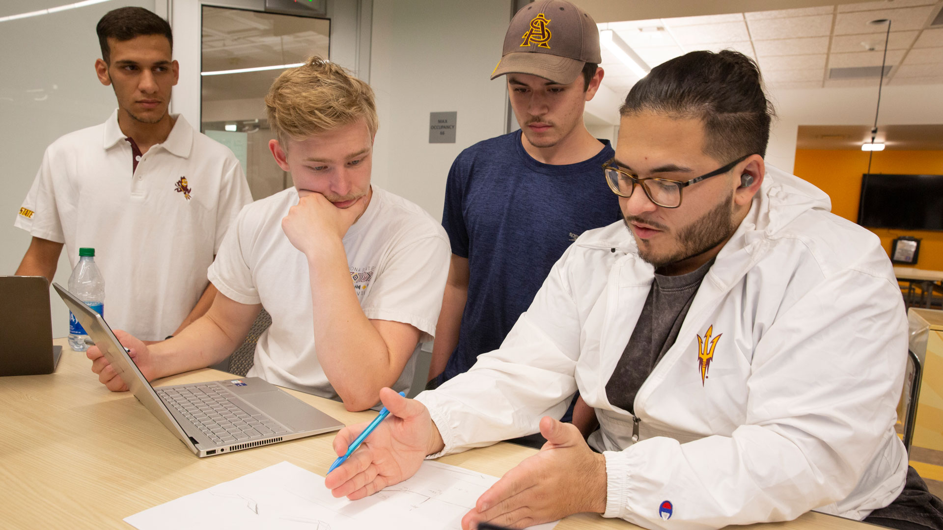 Mateo Oliveras, the incoming president of Solar Devils, works with Rashid Alwashahi, Ronan Gessner and James Nolan at a club meeting.