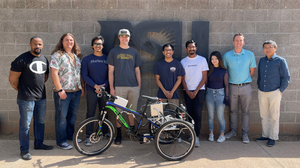 Students of the Fluid Power Vehicle Challenge project pose with their award-winning human-powered trike at ASU’s Polytechnic campus.