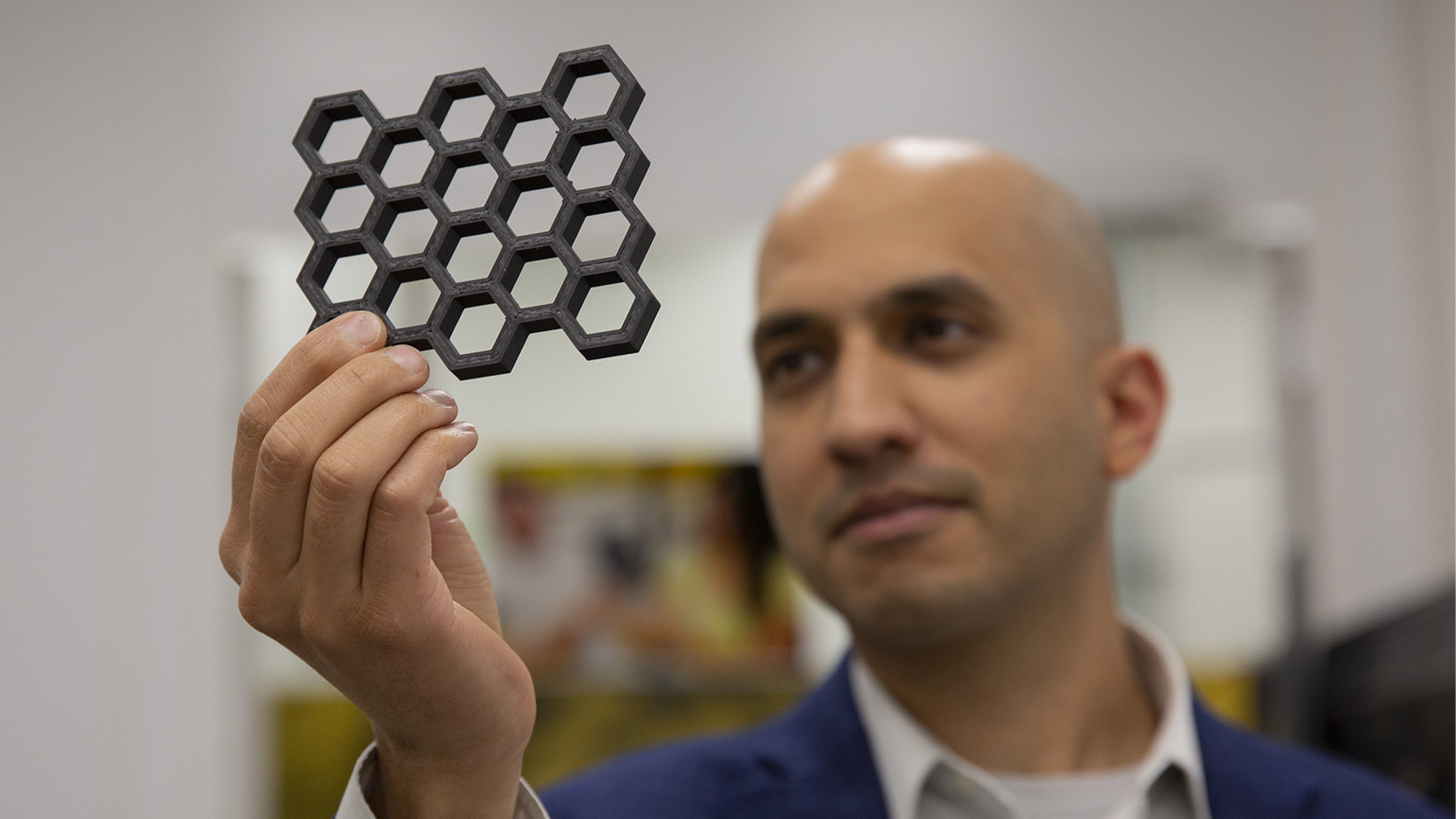 Dhruv Bhate holding up a 3D printed object