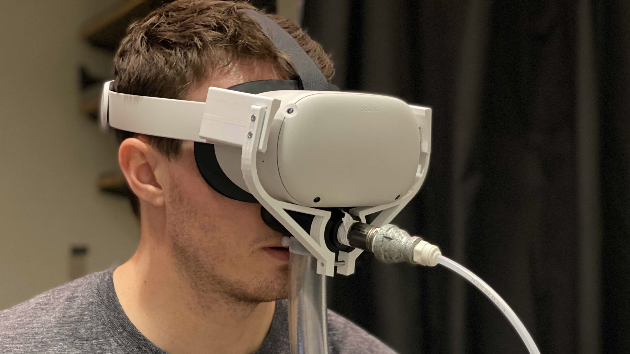 individual wearing a virtual reality smell engine on their head