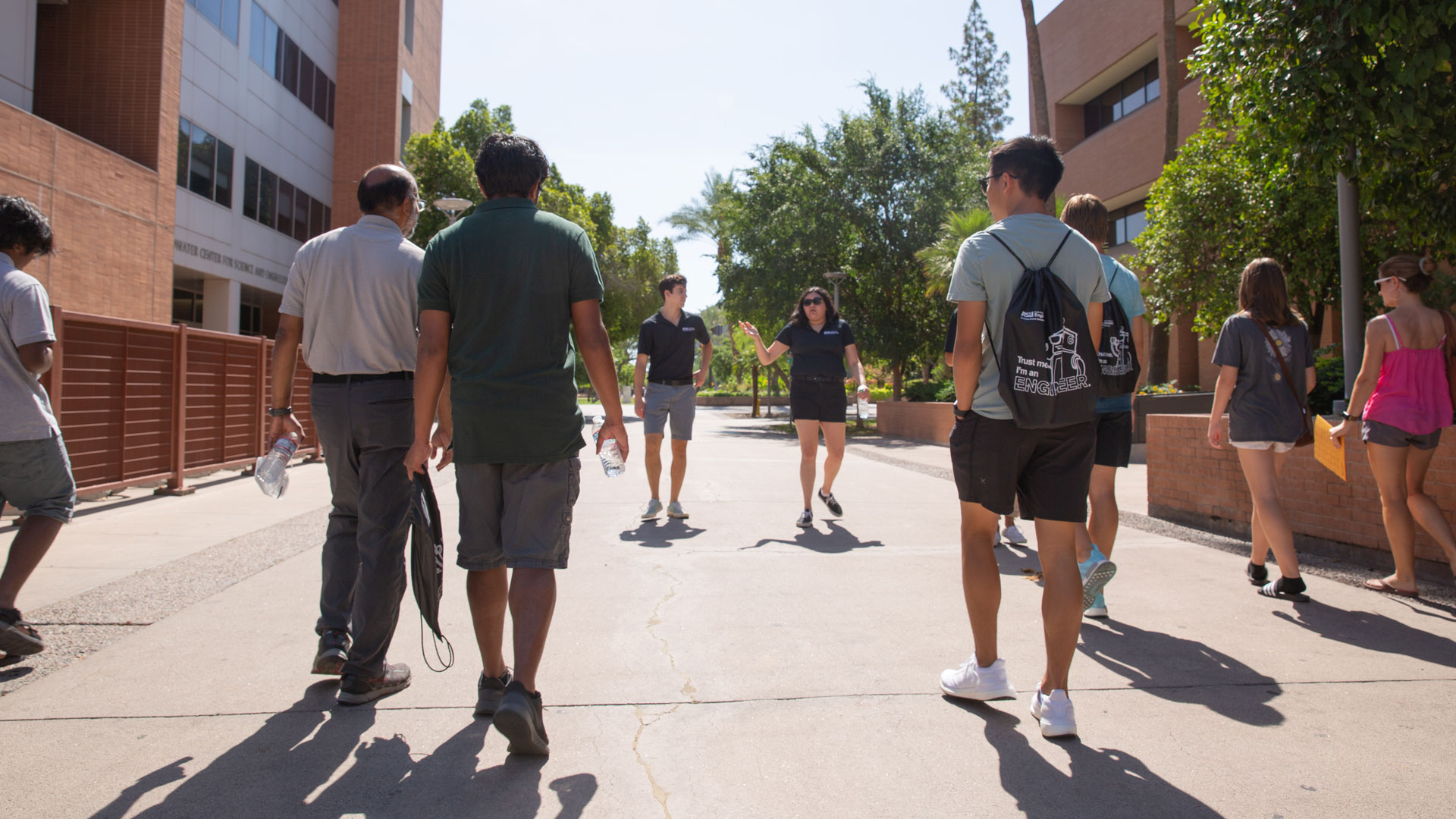 A group of people participate in a tour of the ASU Tempe campus.