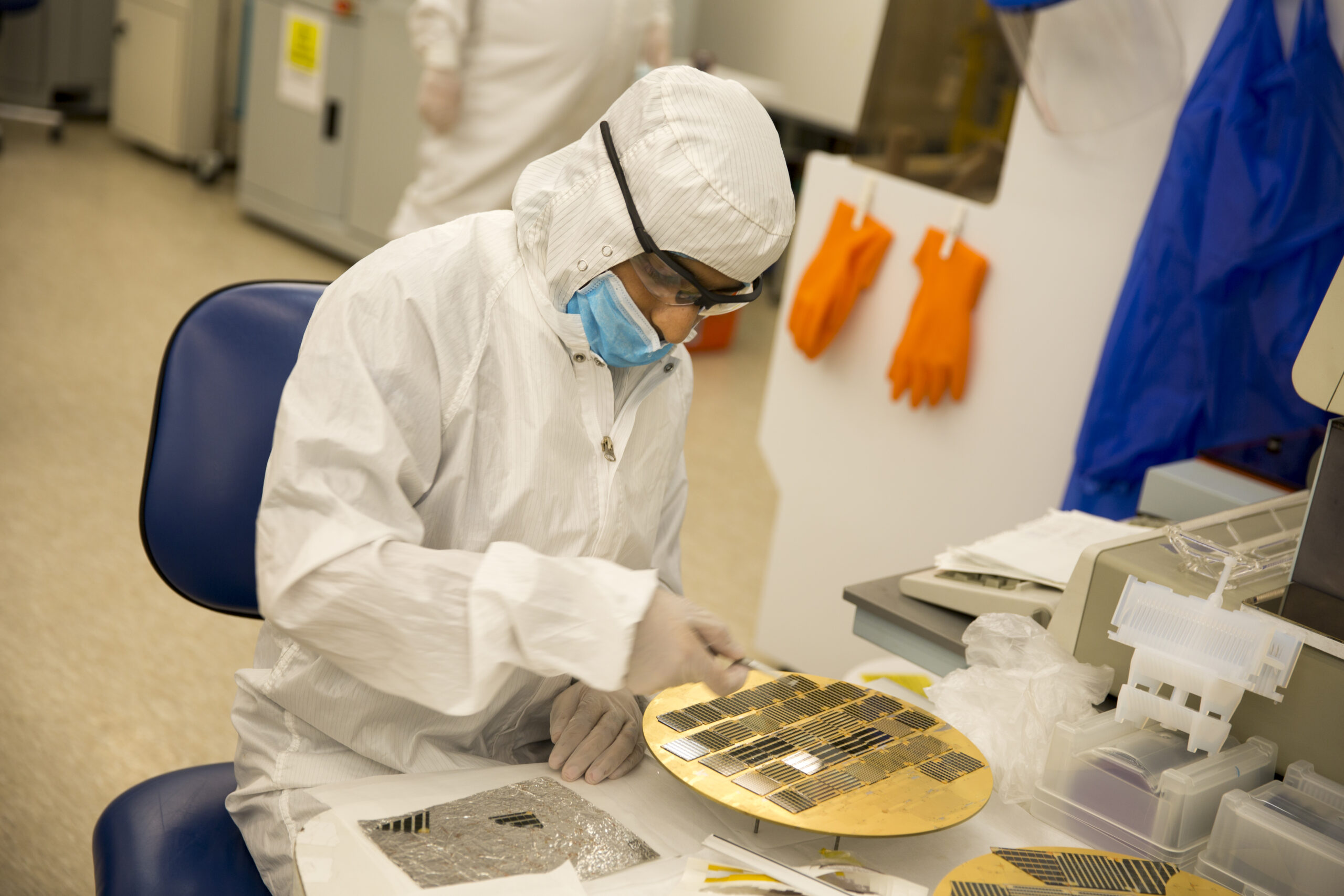 A student conducts research on a computer chip in Trevor Thornton's lab