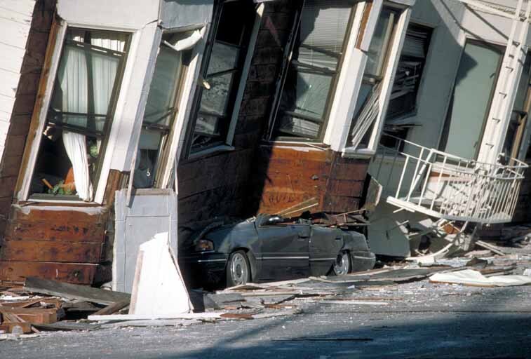 A car crushed by a building following an earthquake