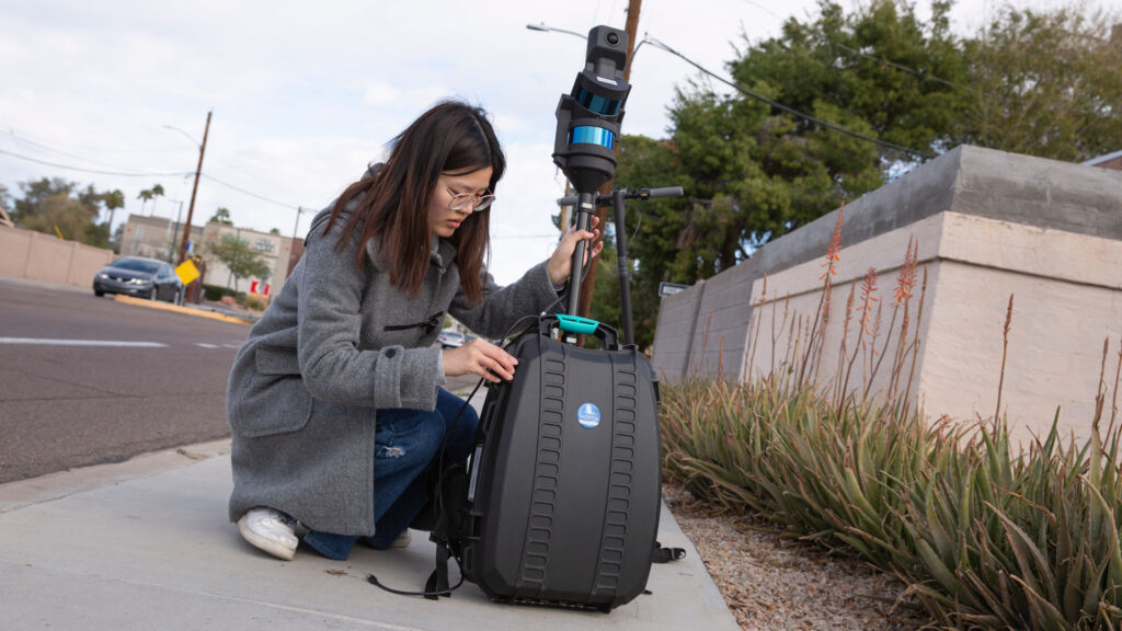 ASU graduate student Chialing Wei inspects the backpack-sized lidar laser scanning system.