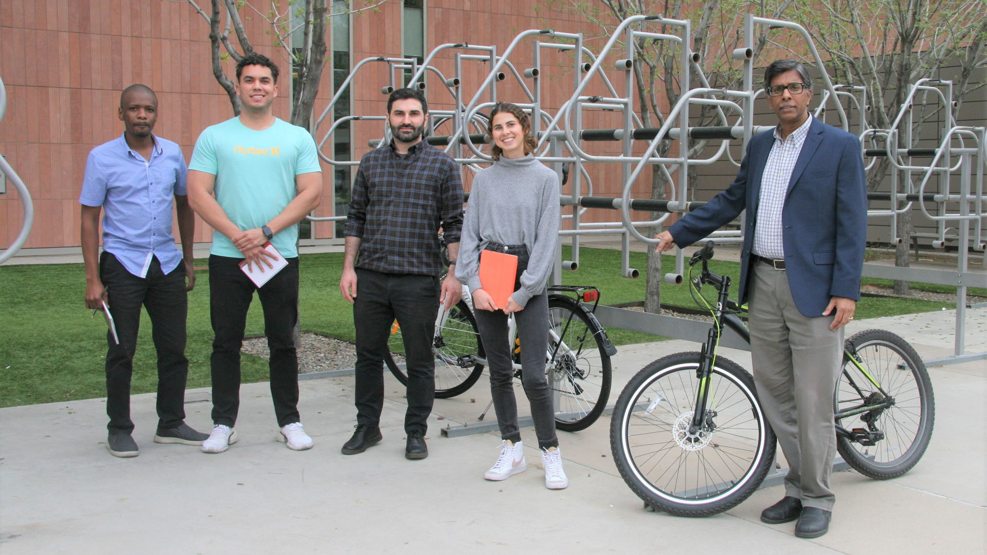 A group photo of Ram Pendyala and his research team with their bicycles.
