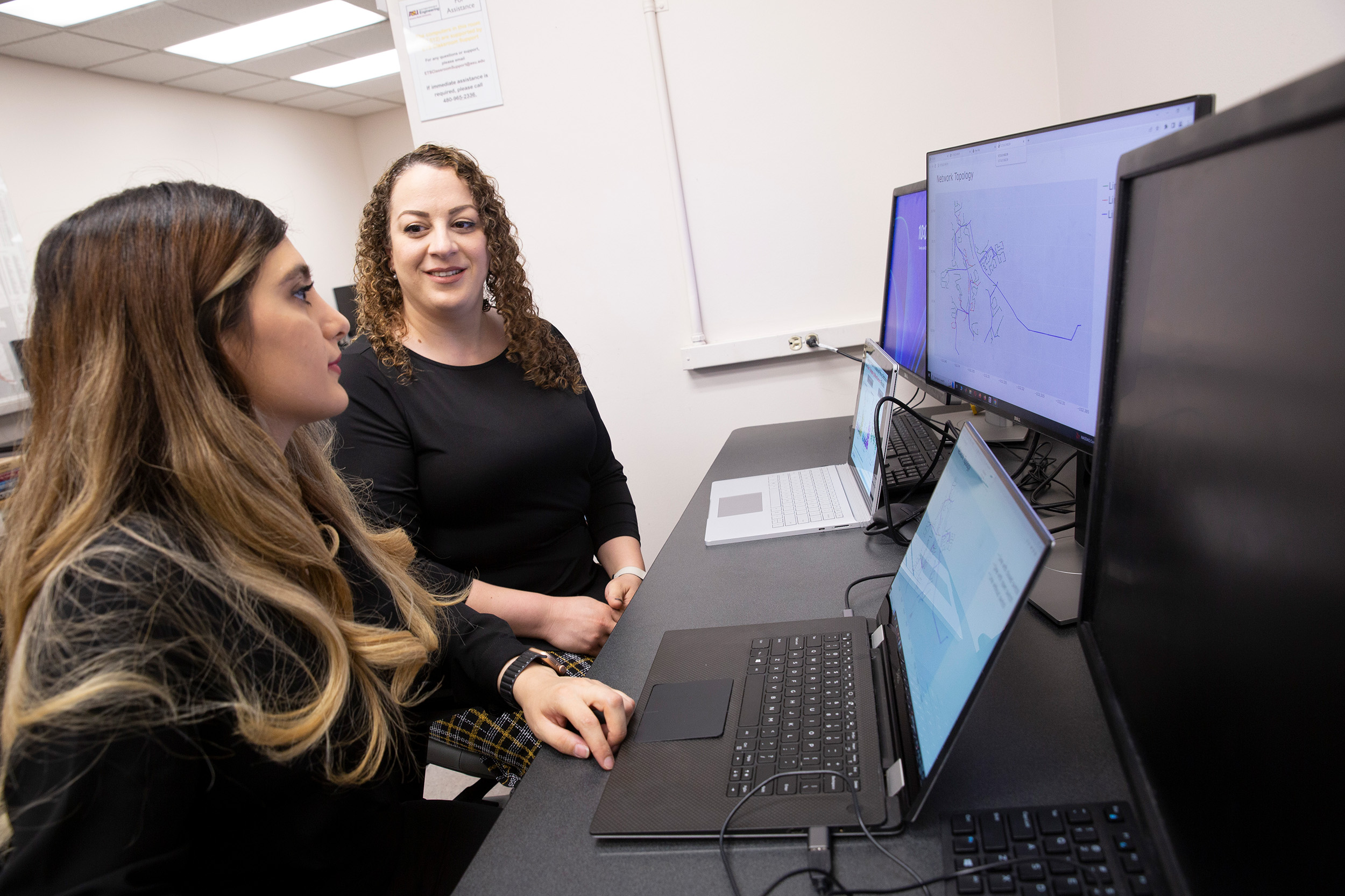 Mojdeh Khorsand Hedman and Zahra Soltani operate a computer program for power grid monitoring.