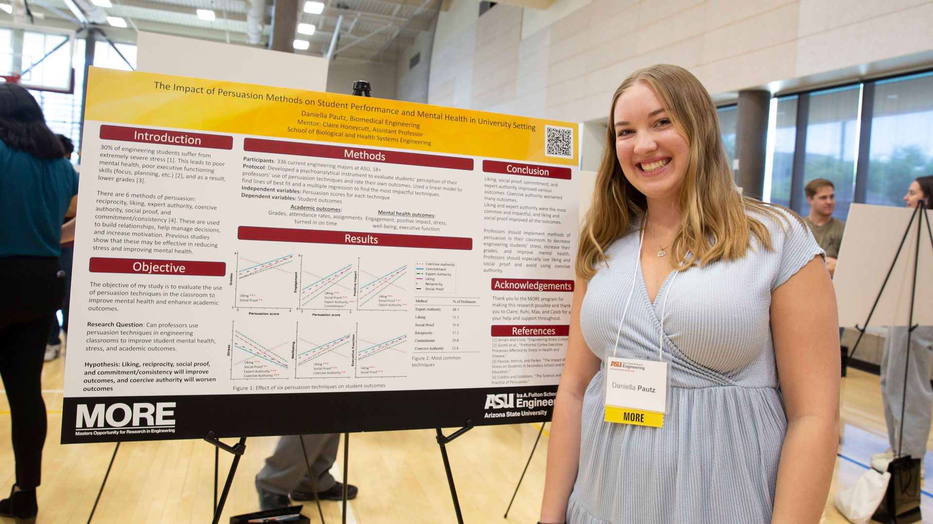 ASU biomedical engineering graduate student Daniella Pautz poses with a research poster presenting her Master’s Opportunity for Research in Engineering project findings.