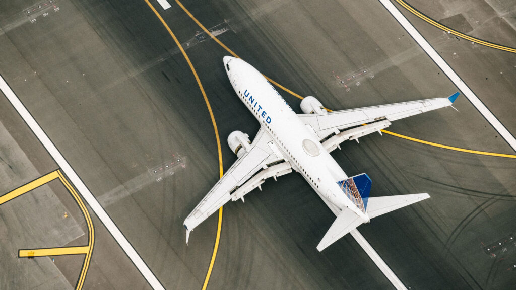 An airplane on the tarmac as seen from above.