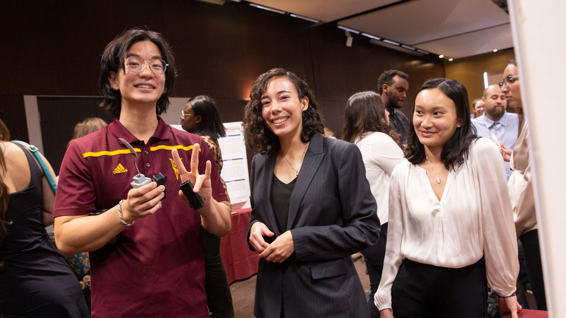 : A group of ASU biomedical engineering students pose with a prototype of their capstone project at the Spring 2023 Capstone Showcase event.
