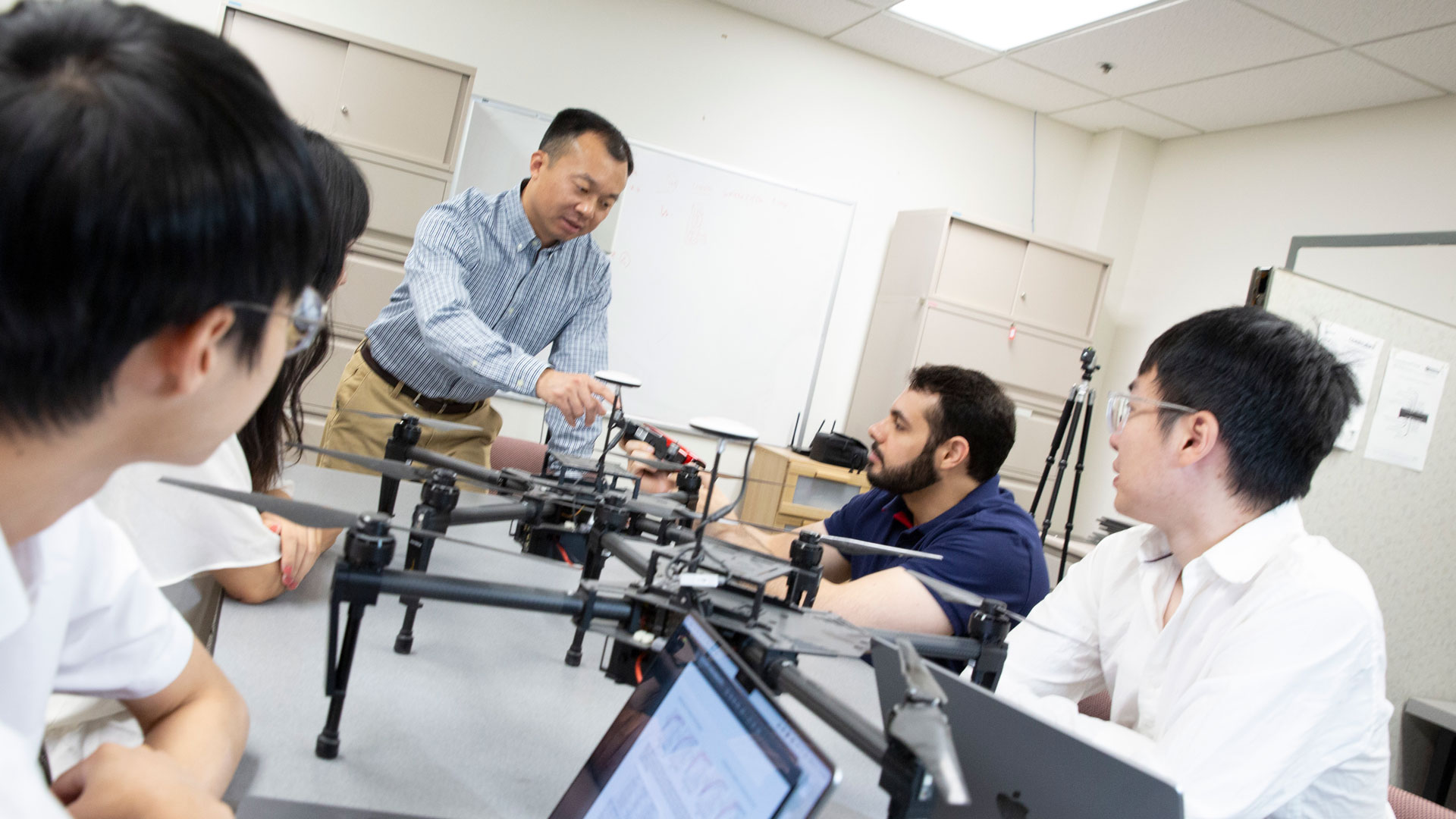 Yanchao Zhang with students and drones