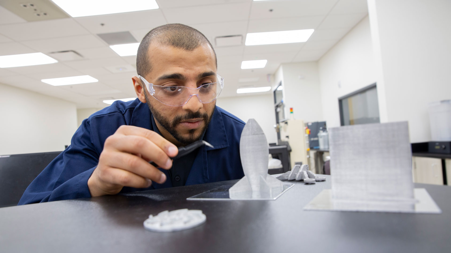 Manufacturing engineering graduate student Mohammed Bawareth works on a MORE research project to advance the understanding of how an additive manufacturing technology that uses sound vibrations can improve the energy efficiency of metal 3D printing.