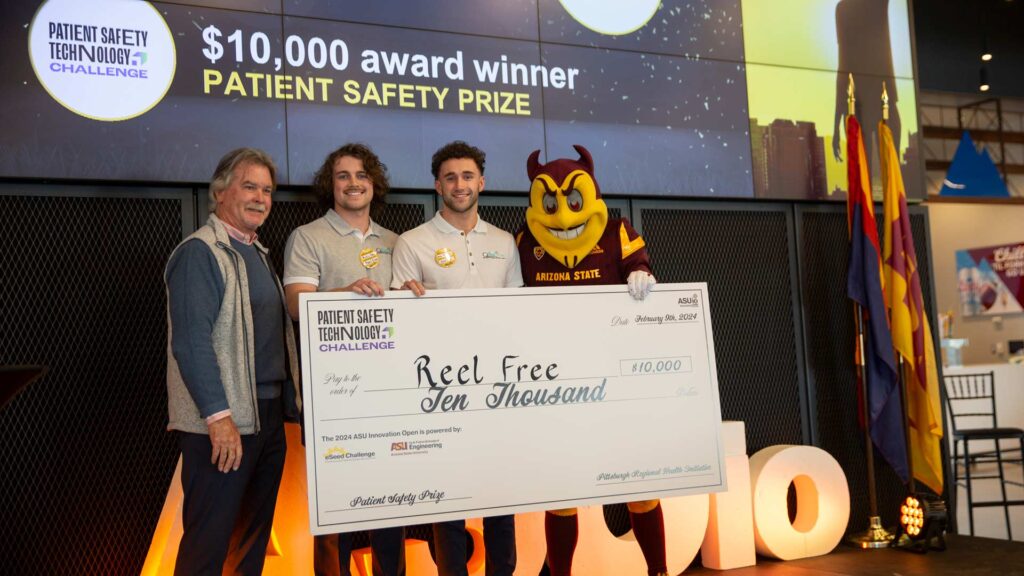 Dr. Dave Mayer and Sparky present the $10,000 PRHI Patient Safety Prize to Reel Free
