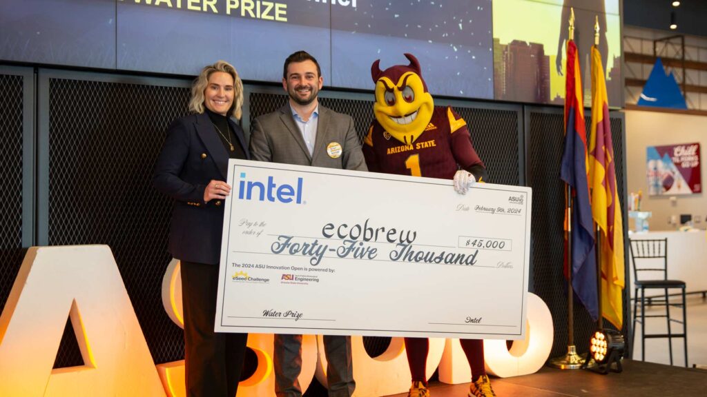 Mackenzie Koenig  and Sparky present Ecobrew with the $45,000 Intel Water Prize