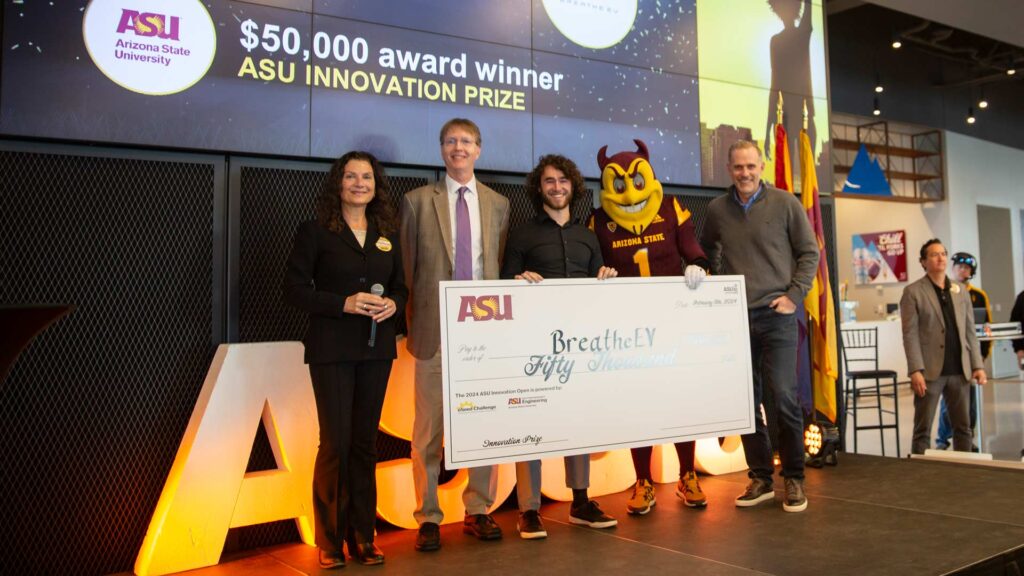 Tracey Dodenhoff, Kyle Squires, Sparky and Cody Friesen present the $50,000 ASU Innovation Prize to BreatheEV 