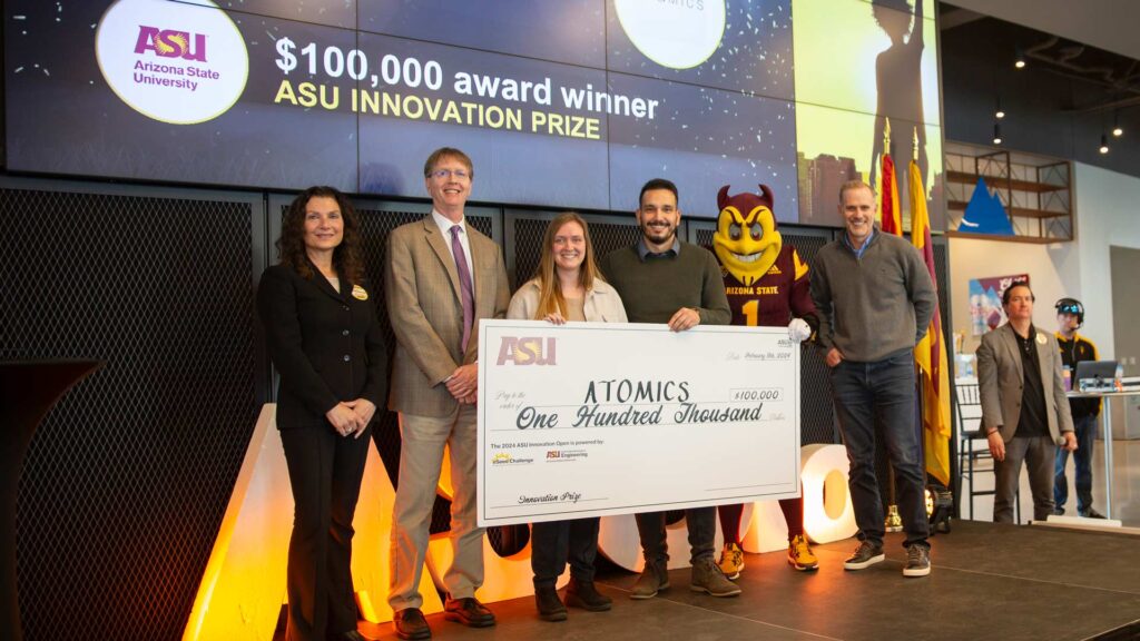 Cody Friesen presents the $100,000 ASU Innovation Prize to ATOMICS team