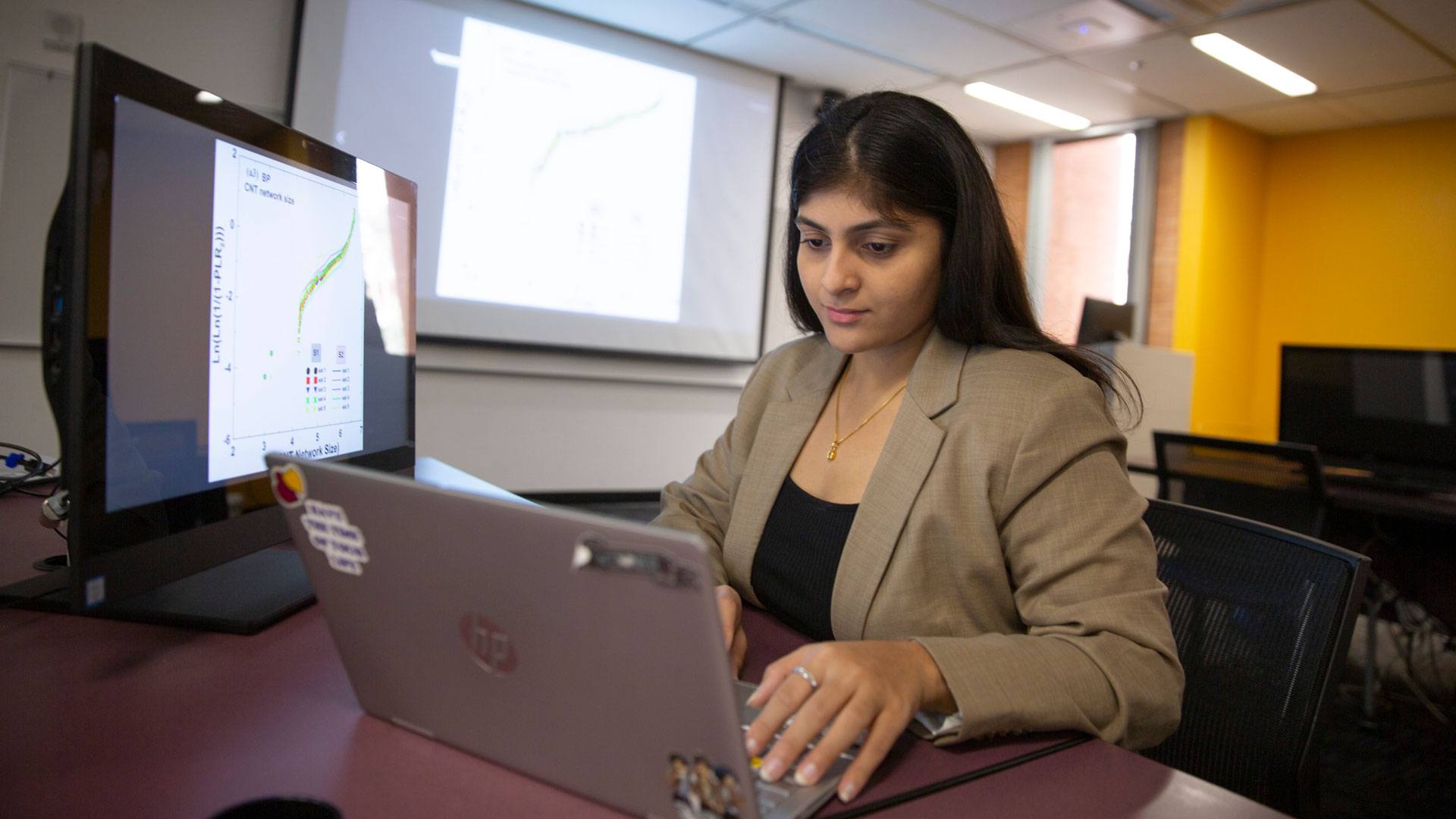 Graduate student Aishwarya Katkar works on a laptop.