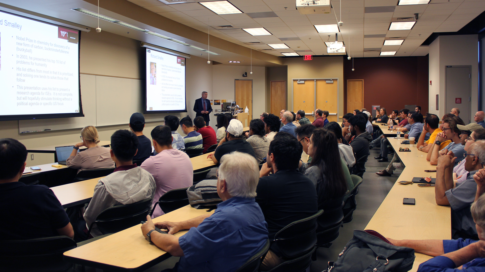 A classroom of people attend a guest lecture.