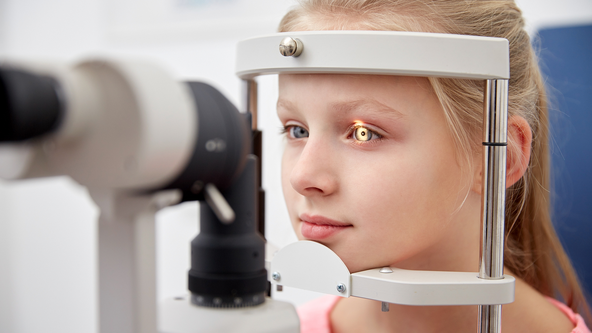 A young girl getting an eye exam.